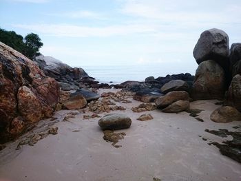 Rocks on beach against sky