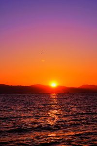 Scenic view of sea against orange sky