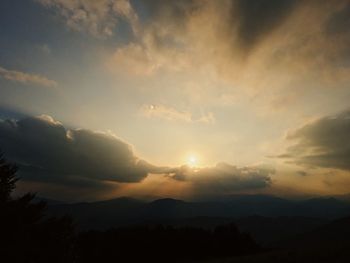 Scenic view of silhouette mountains against sky at sunset