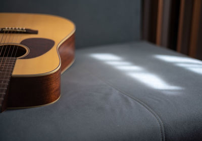 Close-up of guitar on table at home