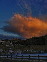 Scenic view of snowcapped mountains against sky during sunset