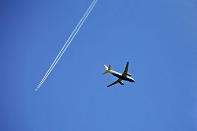 Low angle view of airplane flying in sky