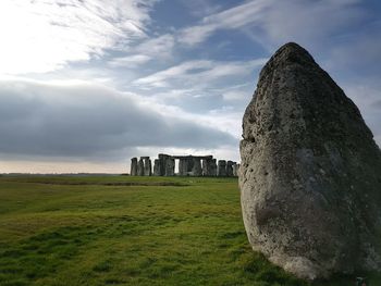 Old ruins on field against sky