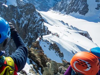 People on snowcapped mountain during winter