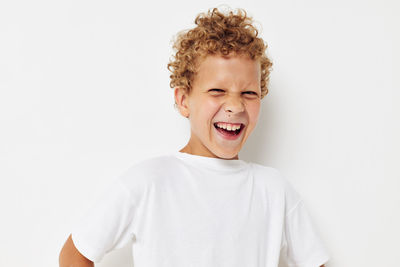 Smiling boy against white background