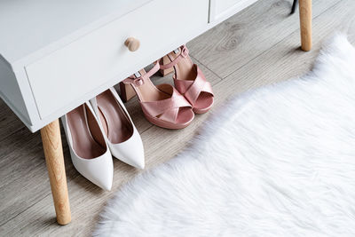 Closeup of elegant high heel shoes standing under feminine dressing table