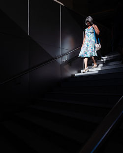 Low angle view of woman walking on staircase