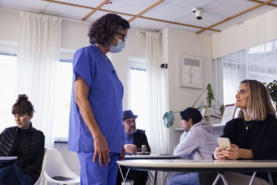 Doctor talking to patient in waiting room