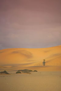 Scenic view of desert against sky during sunset