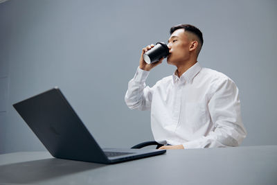 Businessman drinking coffee at office