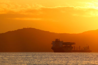 Scenic view of sea against orange sky