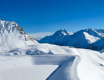 Snowcapped mountains against blue sky