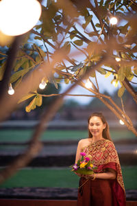 Portrait of woman in traditional clothing standing outdoors