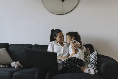 Mother and daughter on sofa