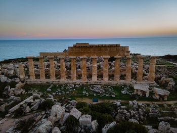 Built structure on sea against clear sky