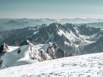 Scenic view of snow covered mountains against sky