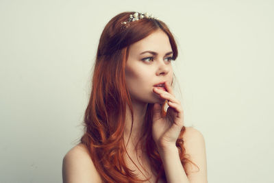 Portrait of beautiful young woman over white background