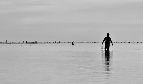 Rear view of man walking on pier