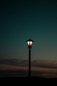 Low angle view of street light against sky at sunset