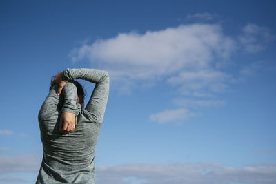 Girl from behind stretching shoulders