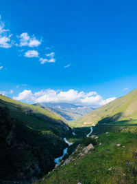 Scenic view of landscape against blue sky