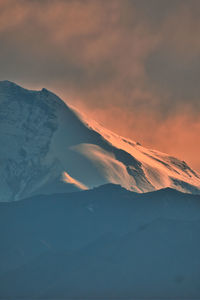 Scenic view of snowcapped mountains against sky during sunset