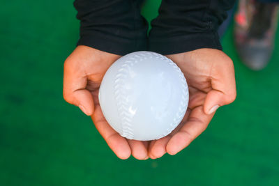 Close-up of person holding ball