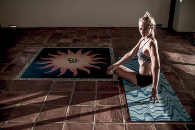 Serious girl doing yoga at sunrise