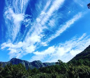 Low angle view of mountains against blue sky