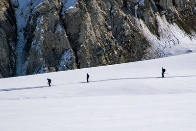 People skiing on snowcapped mountain