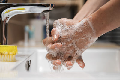 Midsection of woman in bathroom at home