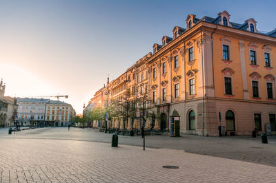 Street amidst buildings in town against clear sky