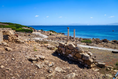 Scenic view of rocks on beach against sky