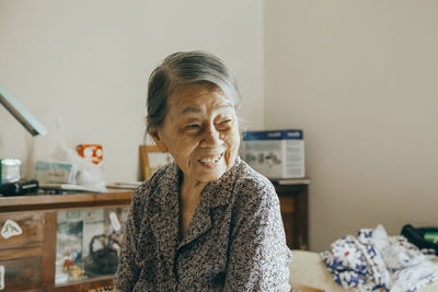 Portrait of woman sitting at home