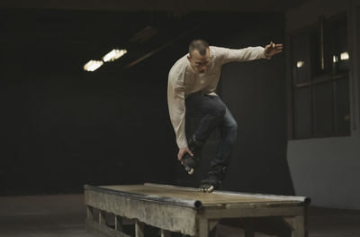 Man inline skating on table