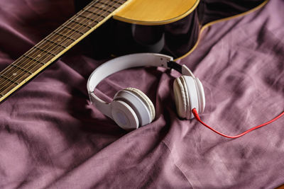 High angle view of guitar on bed