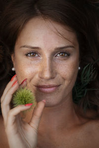 Close-up portrait of a smiling young woman holding ice cream