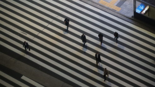 High angle view of people crossing road