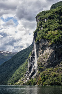 Scenic view of waterfall against sky