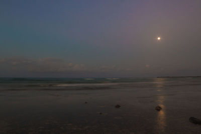 Scenic view of sea against sky at night