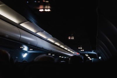 People in illuminated subway station