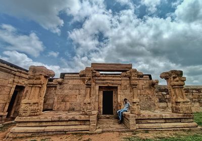 Low angle view of old ruins against cloudy sky