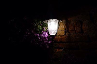 Close-up of illuminated lamp at night