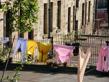 Clothes drying against buildings in city