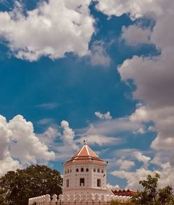 Low angle view of building against cloudy sky