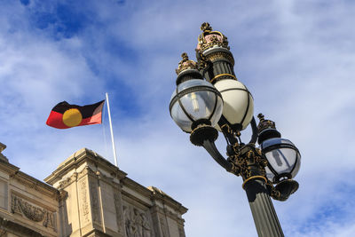 Low angle view of street light against building