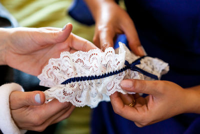 Midsection of woman holding lace