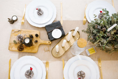 Beautiful table setting with christmas tree decorations in the living room. top view