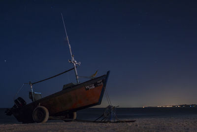 Ship on sea against clear sky at night