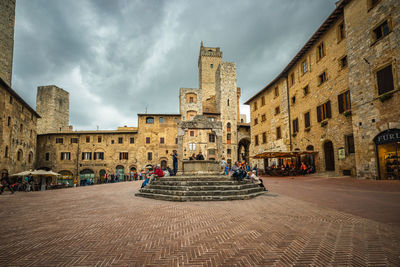 People on street amidst buildings in town